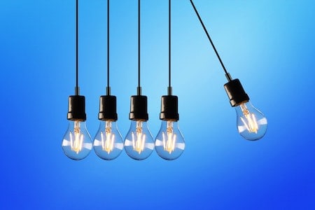 A group of light bulbs hanging on a blue background.