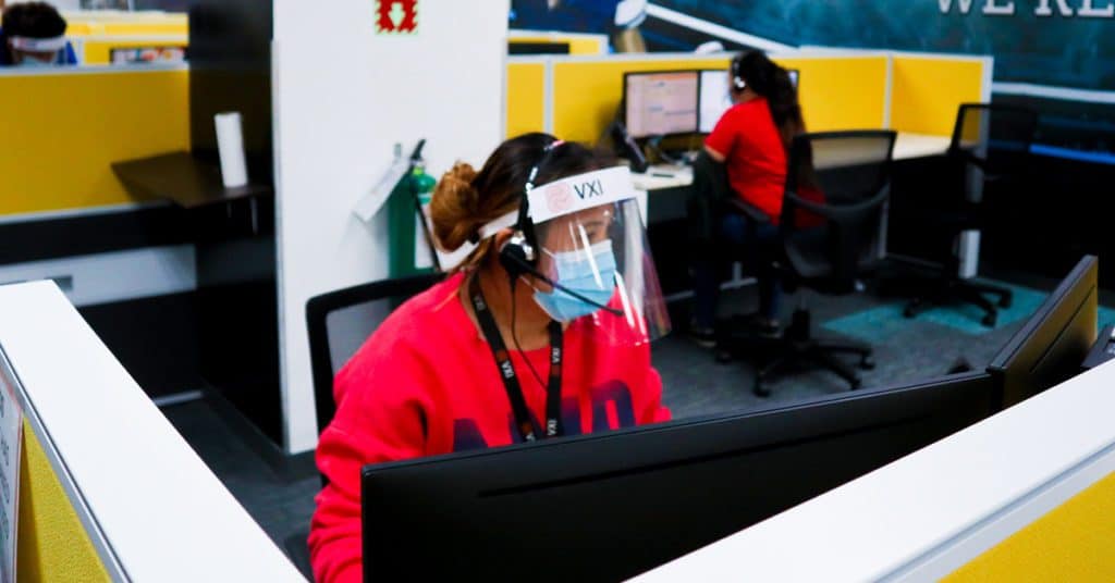 Photo of a VXI call center employee wearing protective face masks while working during the 2019 pandemic